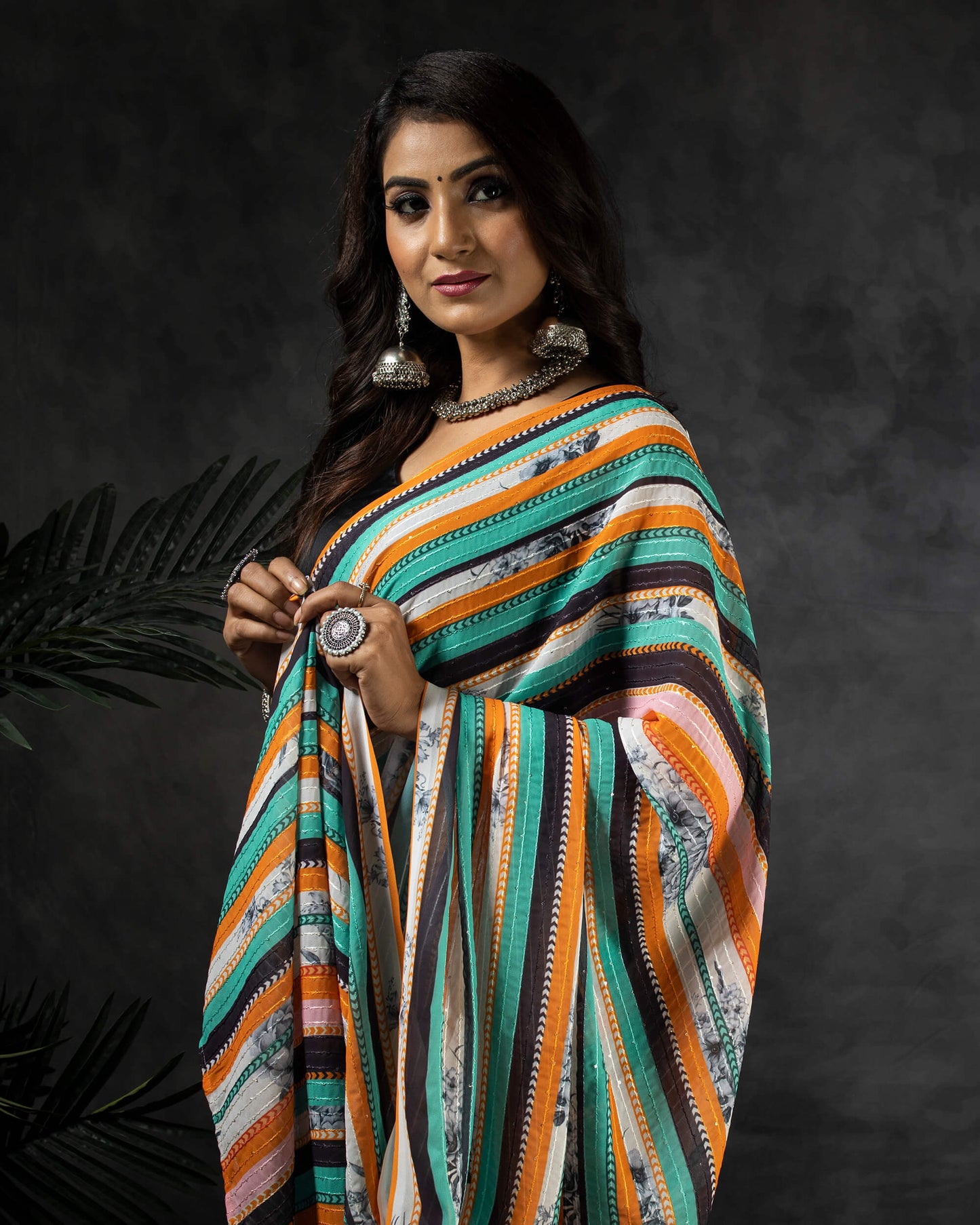 Ocean Green And Carrot Orange Stripes Pattern Premium Sequins Georgette Saree With Tassels