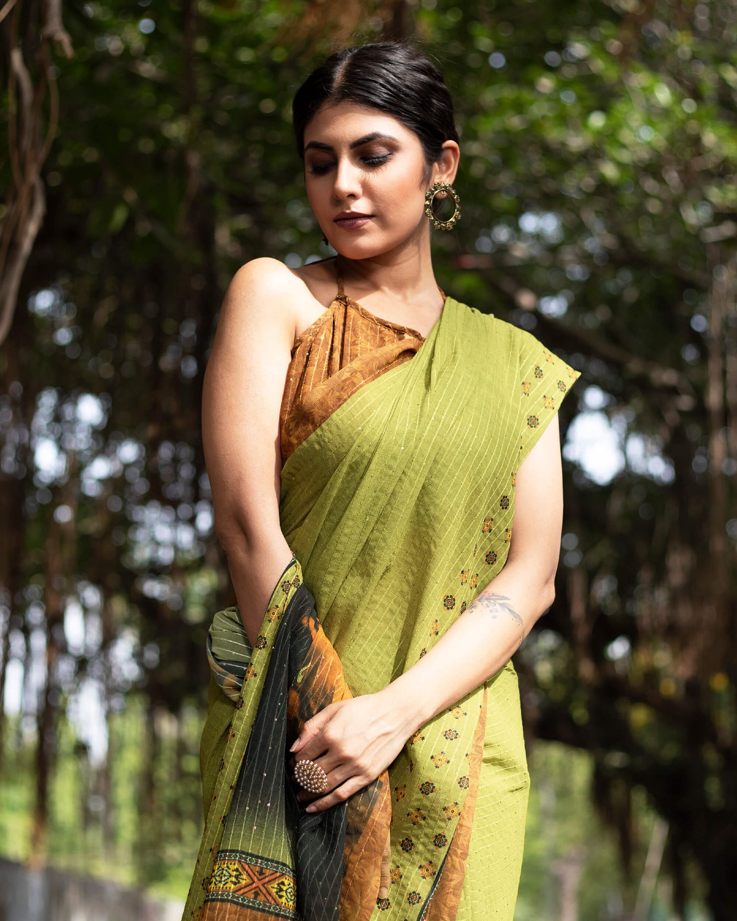 Olive Green And Black Quirky Pattern Premium Sequins Georgette Saree With Tassels