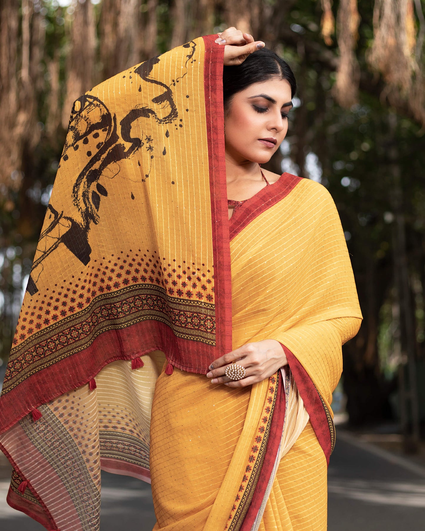 Merigold Yellow And Black Quirky Pattern Premium Sequins Georgette Saree With Tassels