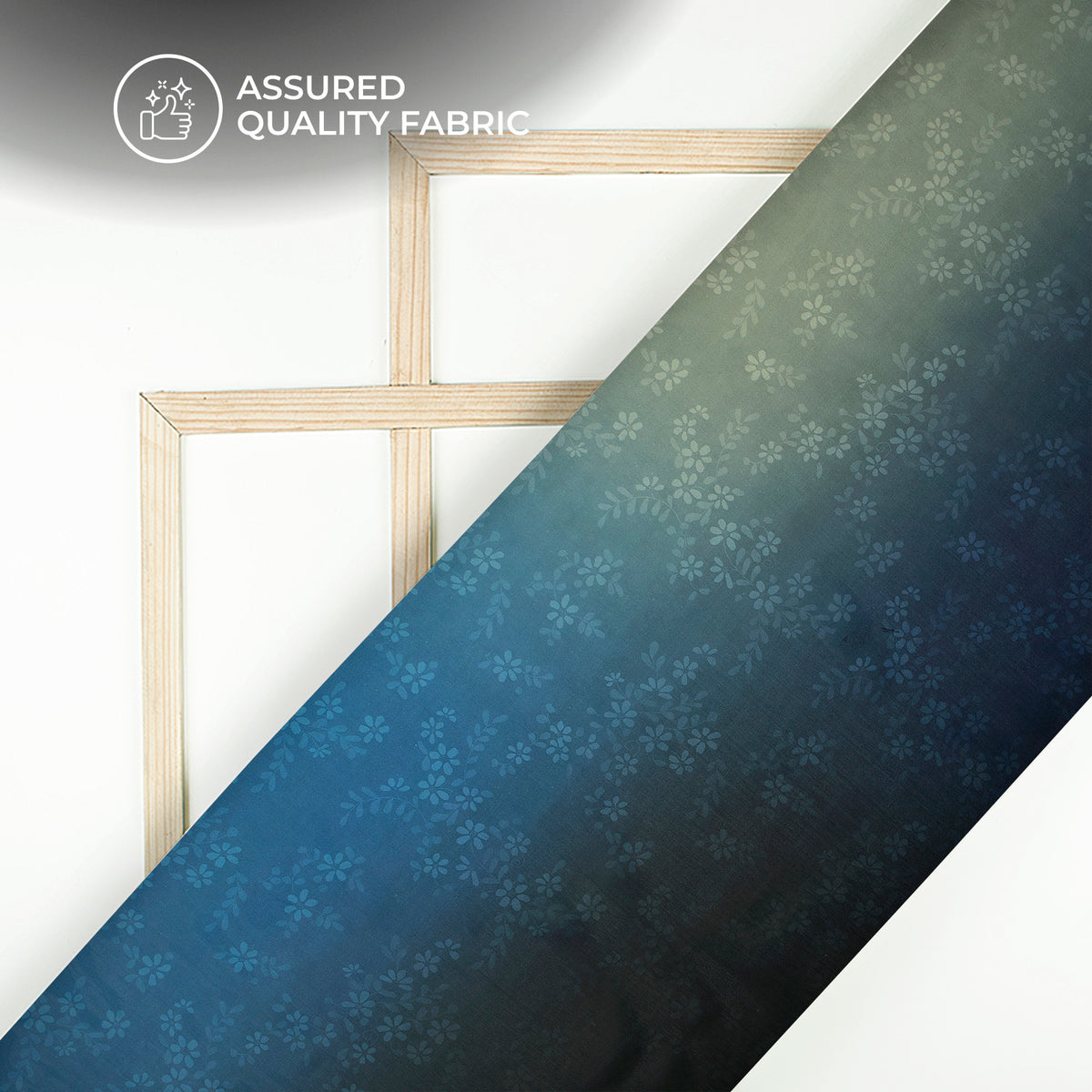 Blue fabric with floral pattern draped over a white surface with a gold frame.