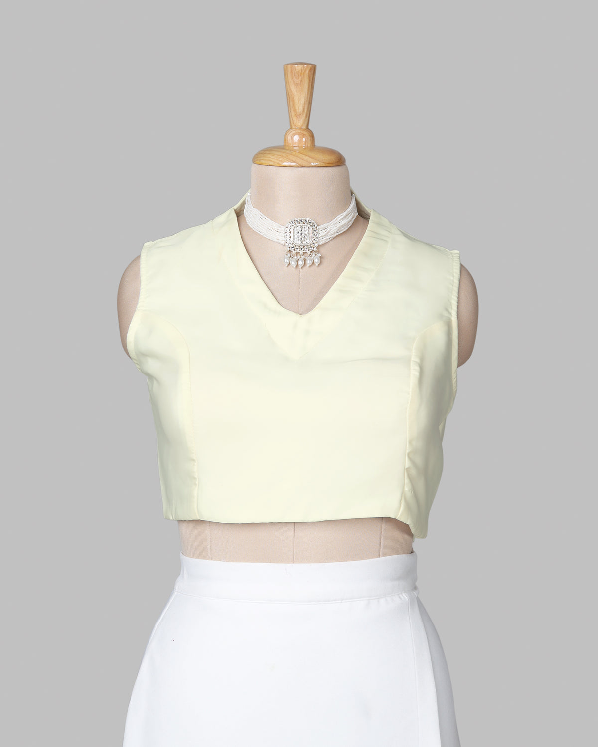 Off White Plain Sleeveless V-Neck Blouse