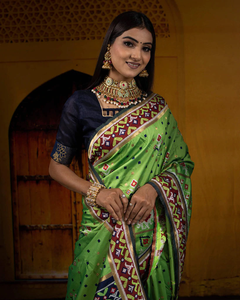 Parakeet Green And Navy Blue Patola Pattern Zari Jacquard Bordered Premium Banarasi Silk Saree With Blouse