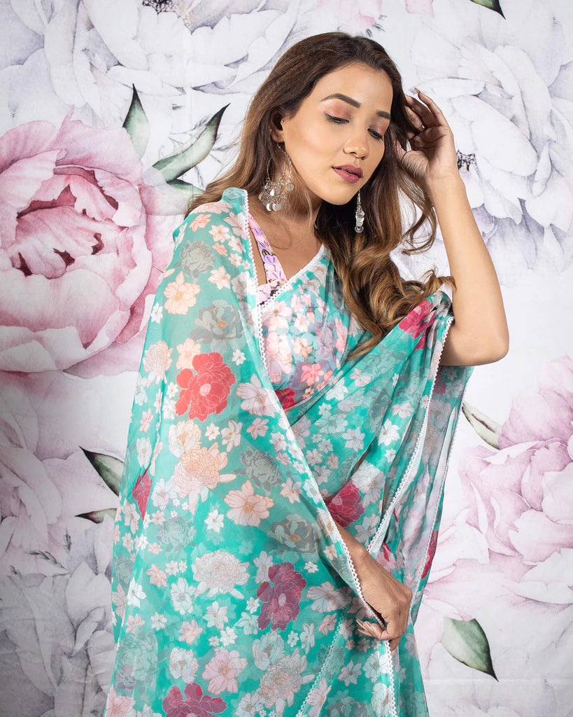 Tuquoise And Pink Floral Pattern Organza Saree With Pearl Work Lace Border