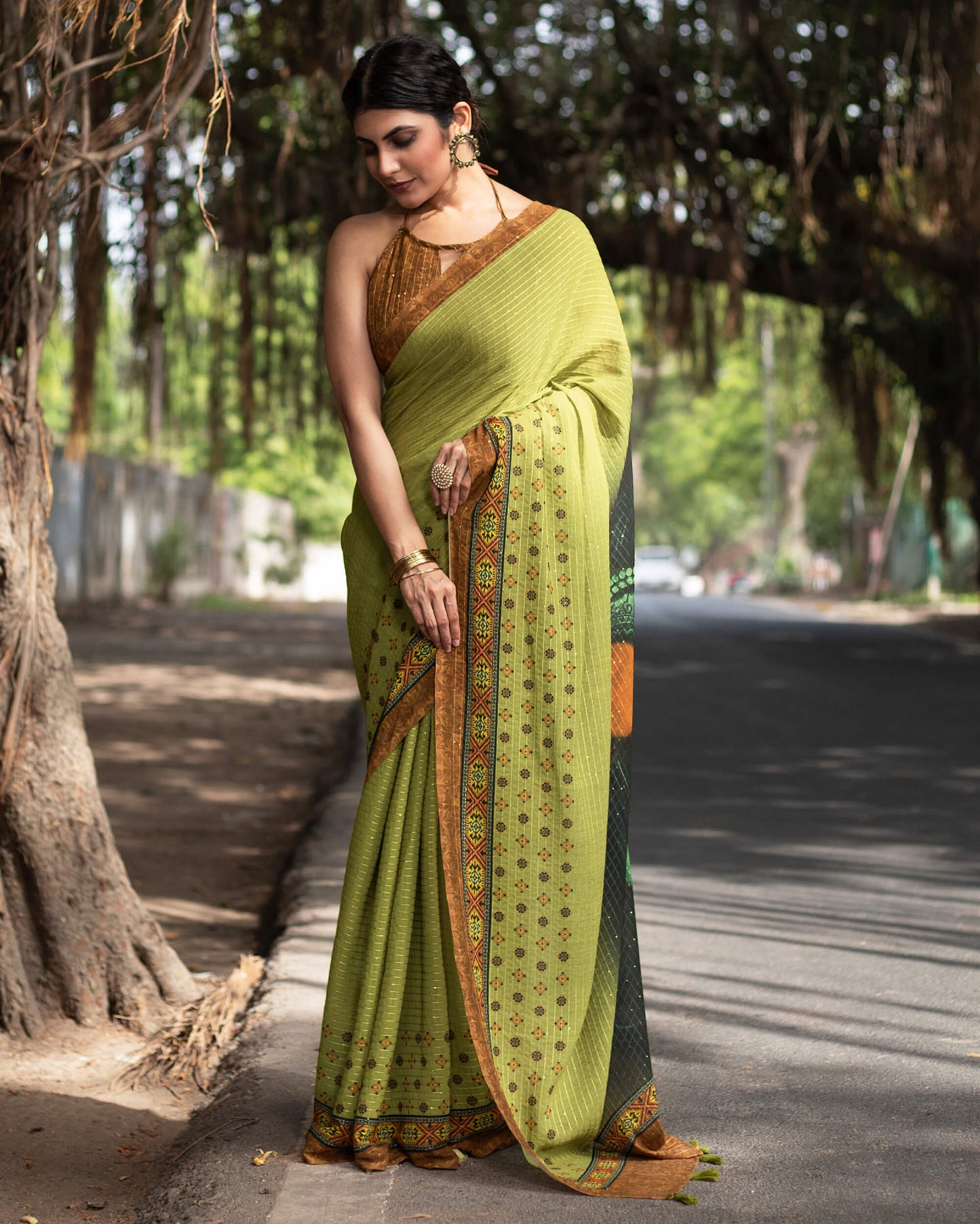 Olive Green And Black Quirky Pattern Premium Sequins Georgette Saree With Tassels